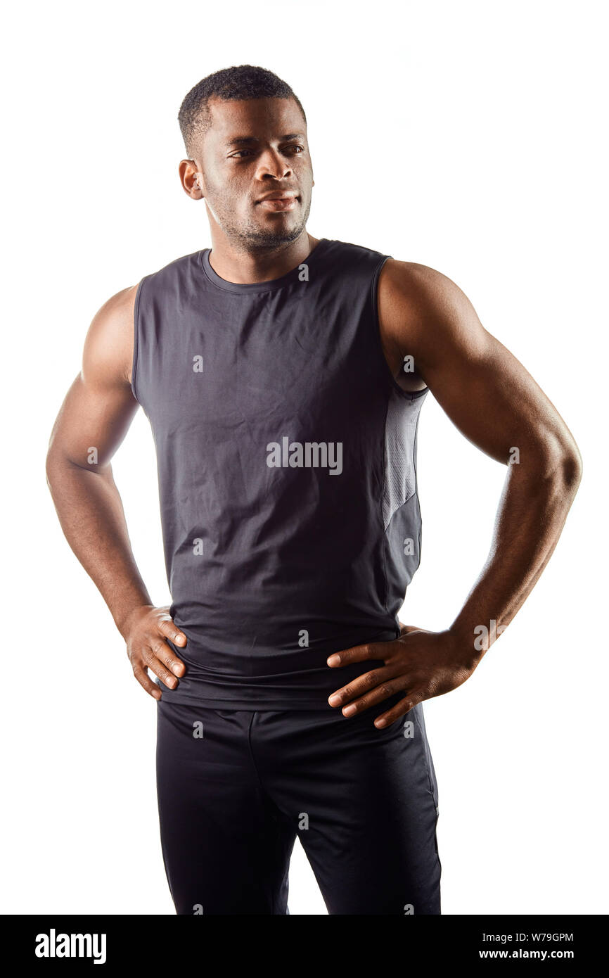 confident handsome young african man standing with hands on the hips ...