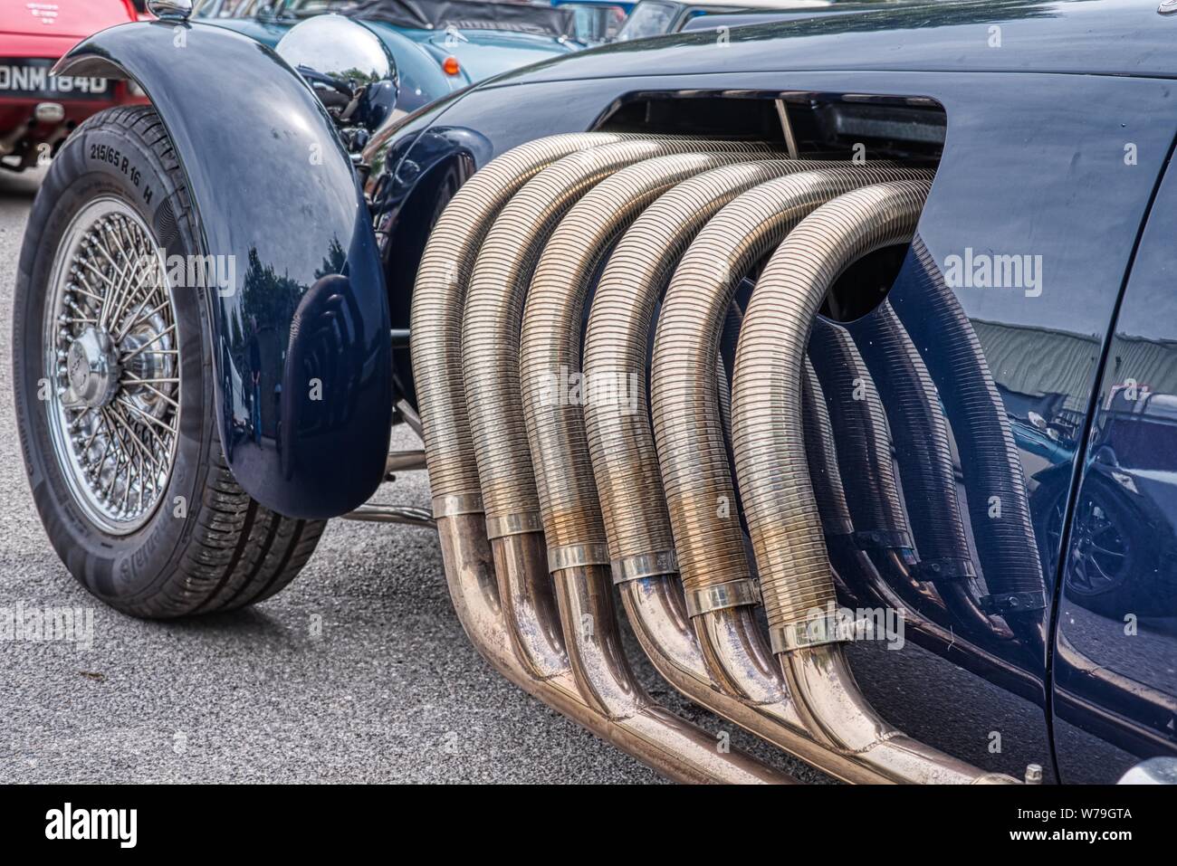 Giant exhaust system on a Ronart W152 car at Bill Rawles Classic Cars, Medstead, Hampshire, UK Stock Photo