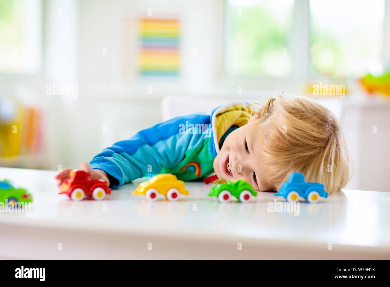 Little Boy Playing Toy Cars Young Kid With Colorful Educational