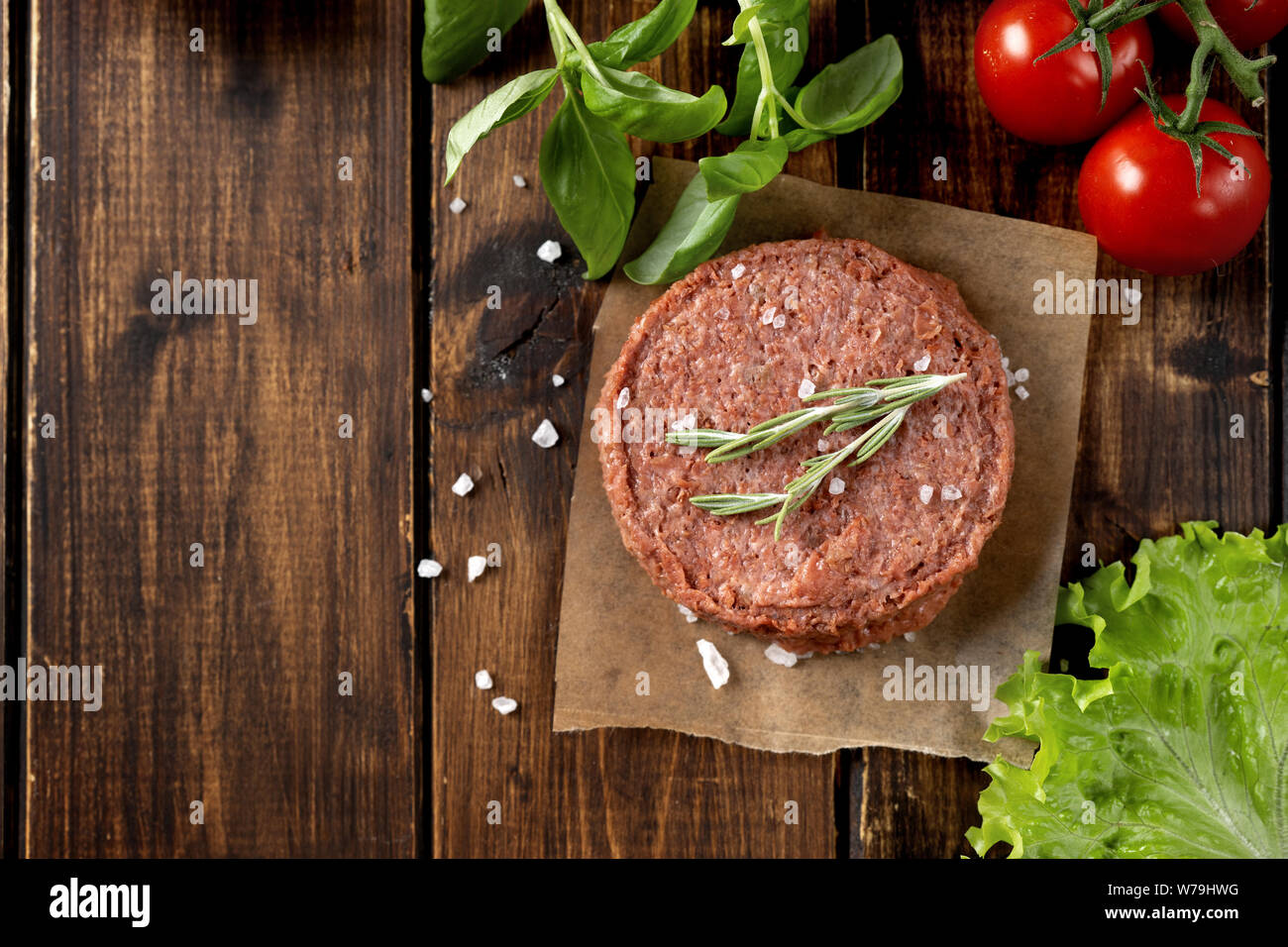 Top view of raw vegan patty on dark wooden background. Copy space Stock Photo