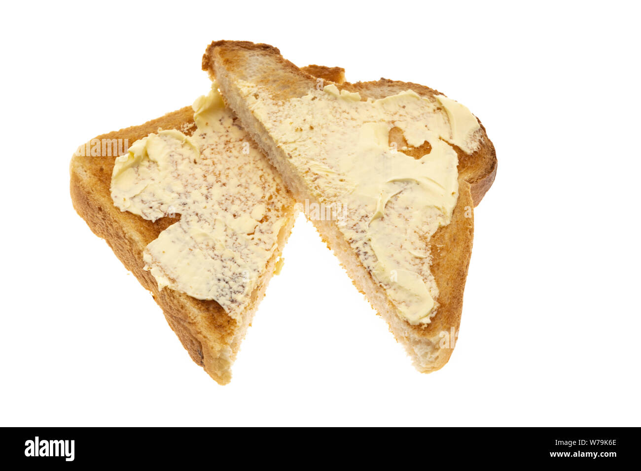 Toasted white bread spread with butter white background Stock Photo