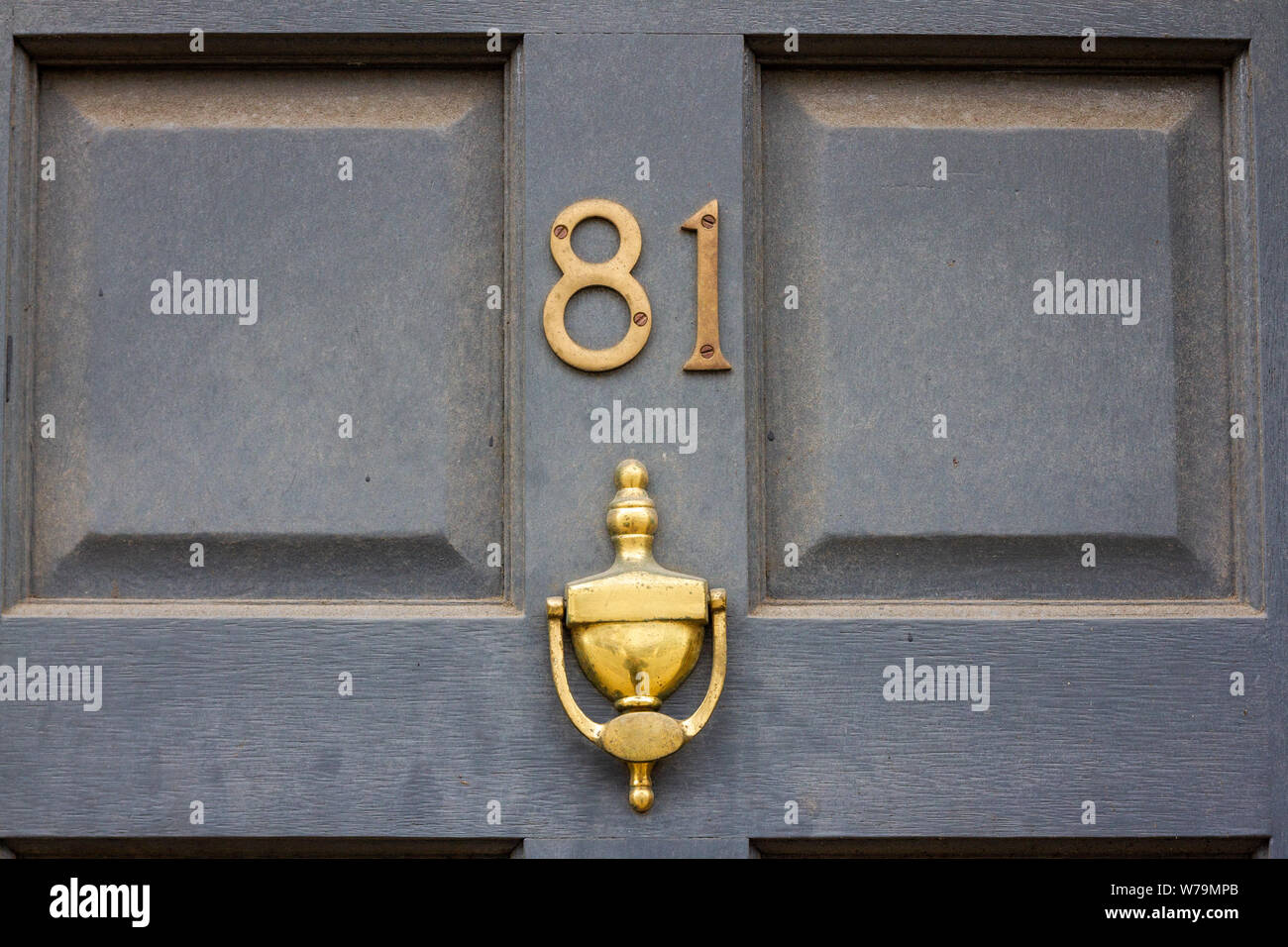 House number 81 with golden door knocker Stock Photo