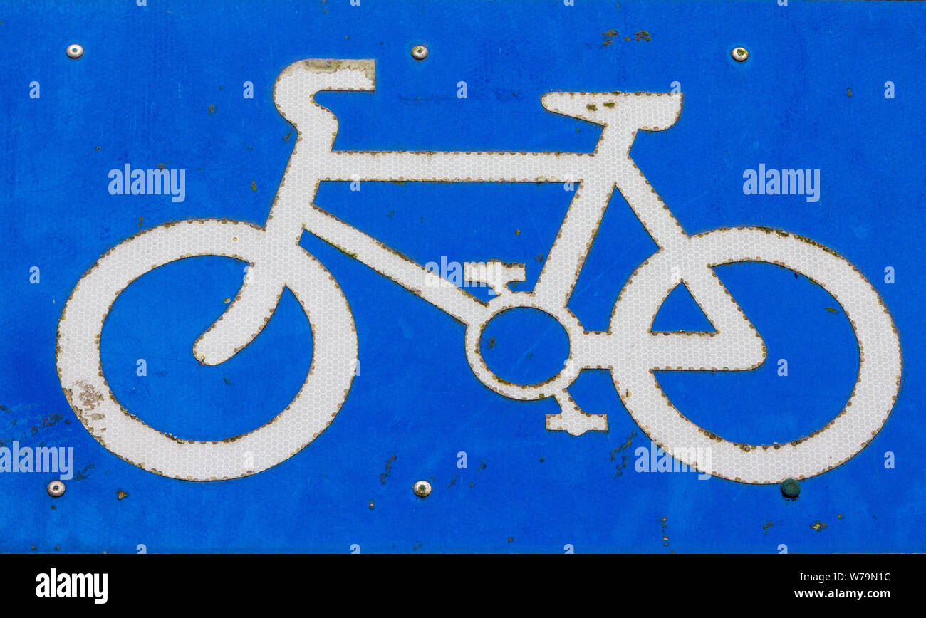 Worn and weathered sign for a bicycle lane Stock Photo