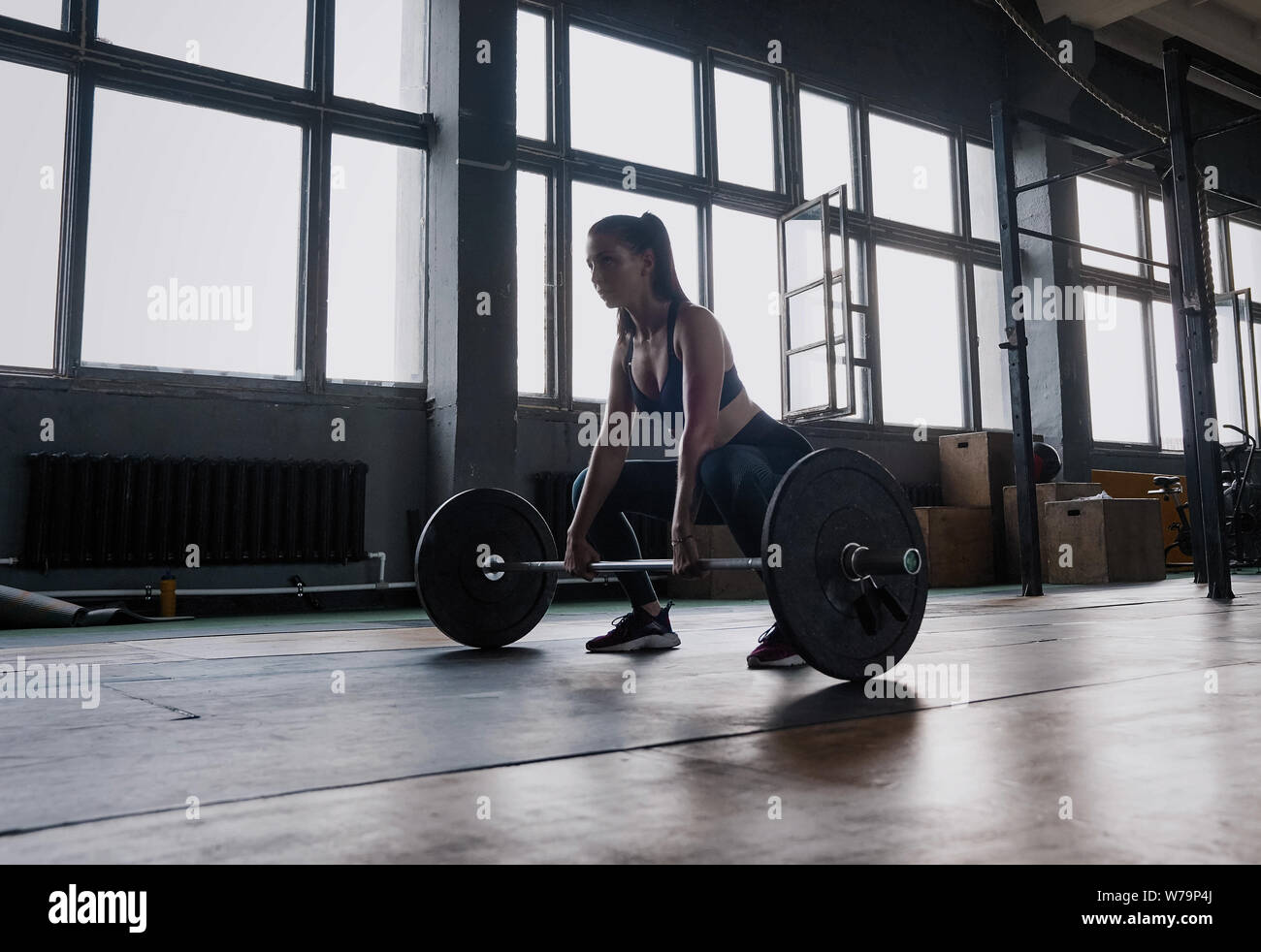 Focused on success. Attractive strong muscular female bodybuilder doing