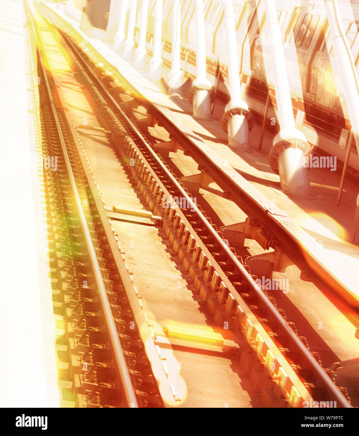 Single point perspective image of a burning metro rails and suspenders of a bridge in a dizzy look. Global warming and heatwave concepts. Stock Photo