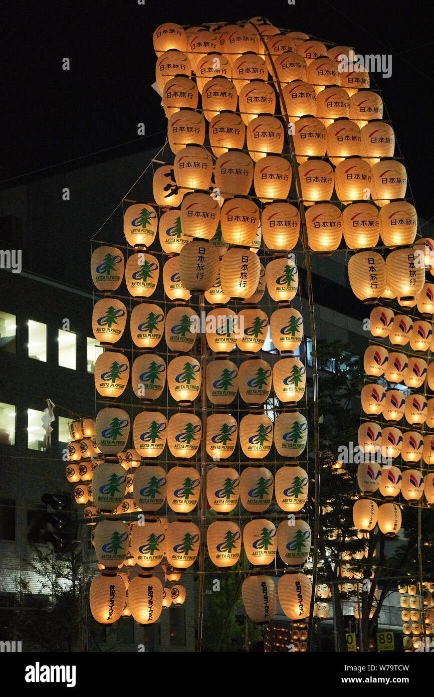 Traditional candlelit Japanese lanterns are raised on bamboo poles and paraded at the Akita Kanto Matsuri Festival in 2016. Stock Photo