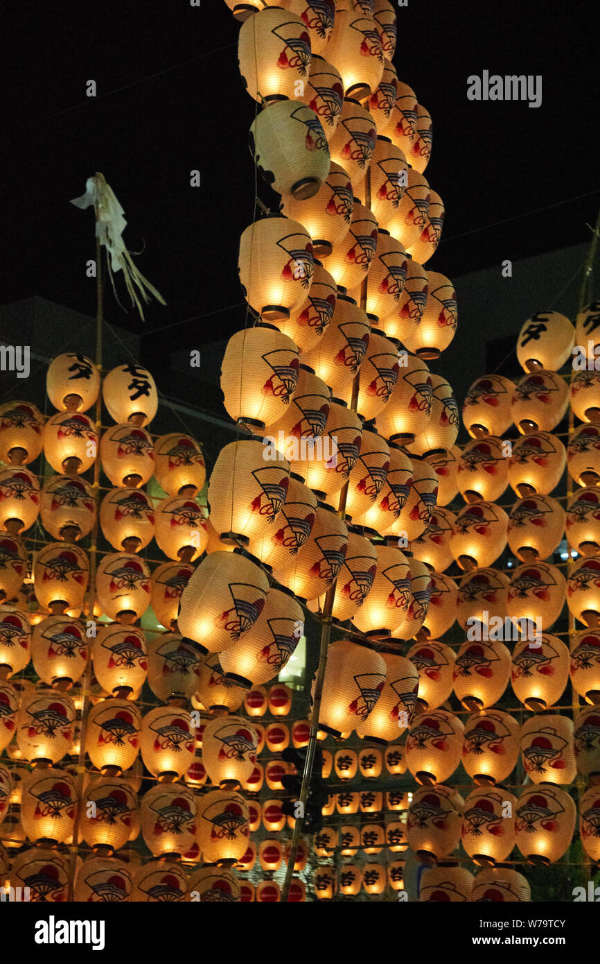 Traditional candlelit Japanese lanterns are raised on bamboo poles and paraded at the Akita Kanto Matsuri Festival in 2016. Stock Photo