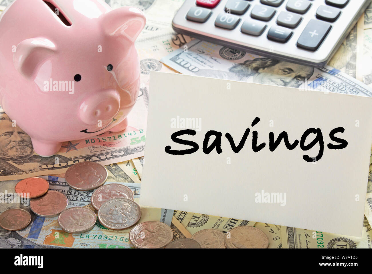 United States bank notes and coins with a calcultor, piggy bank, and a