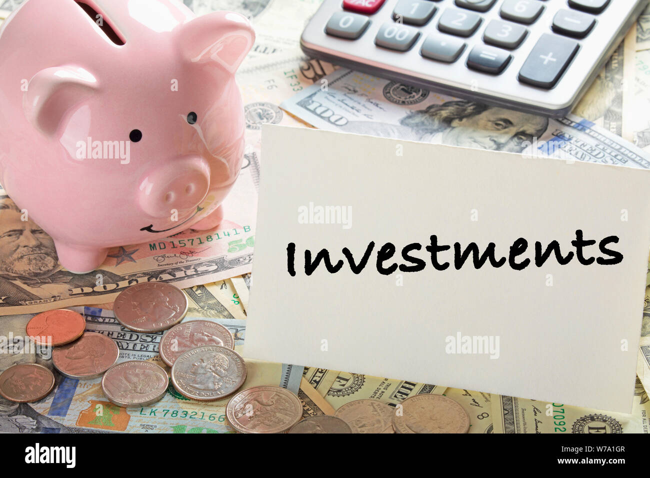 United States bank notes and coins with a calcultor, piggy bank, and a