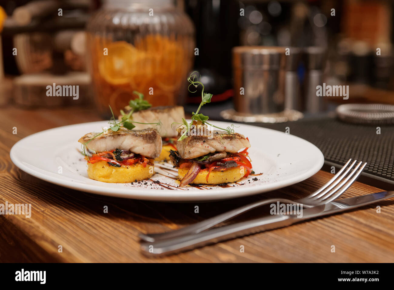Fried fish fillet and polenta served on bar counter Stock Photo Alamy