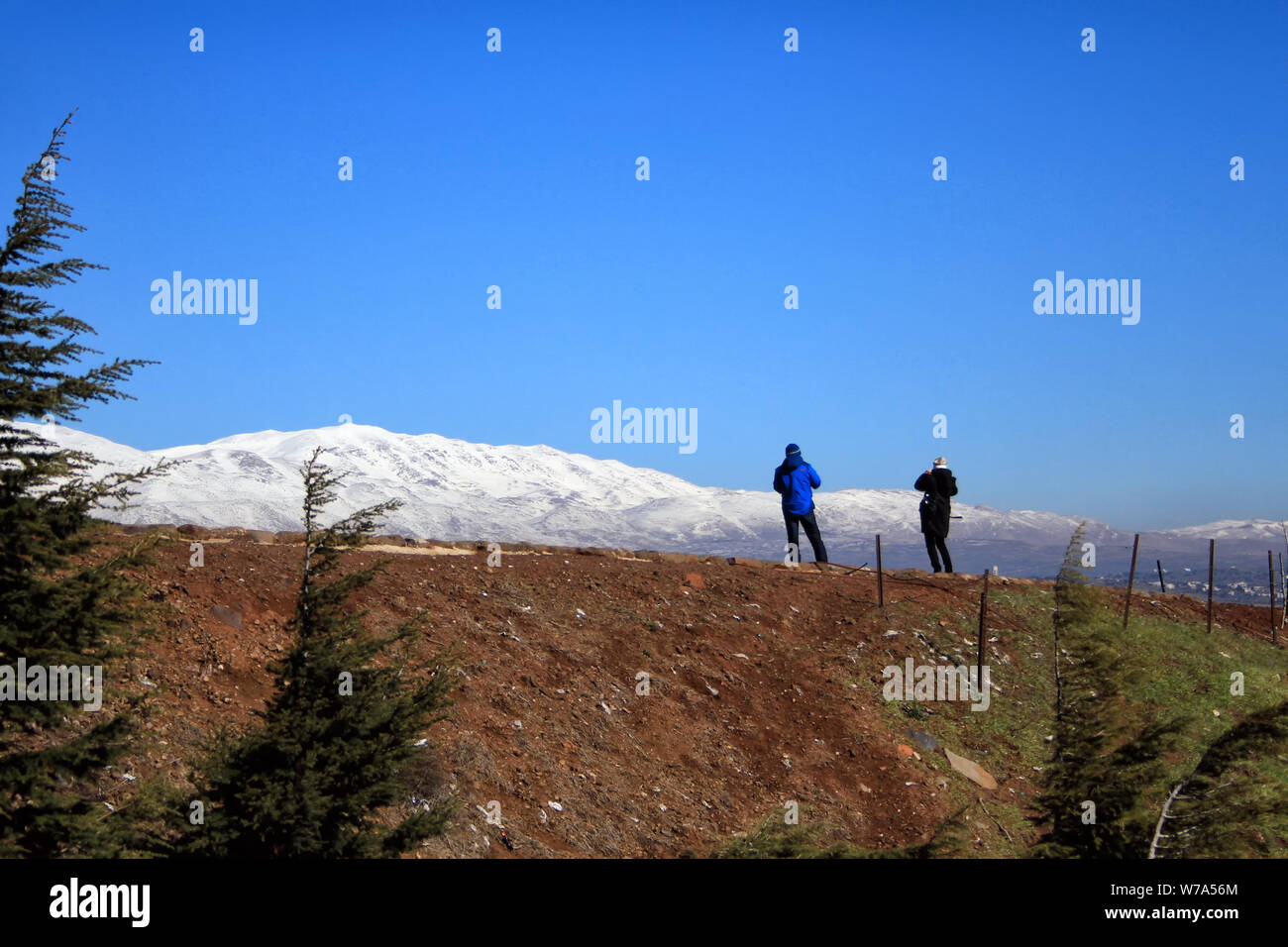 Two people stand at the Oz 77 Memorial at the Valley of Tears and look towards Mount Hermon. Stock Photo