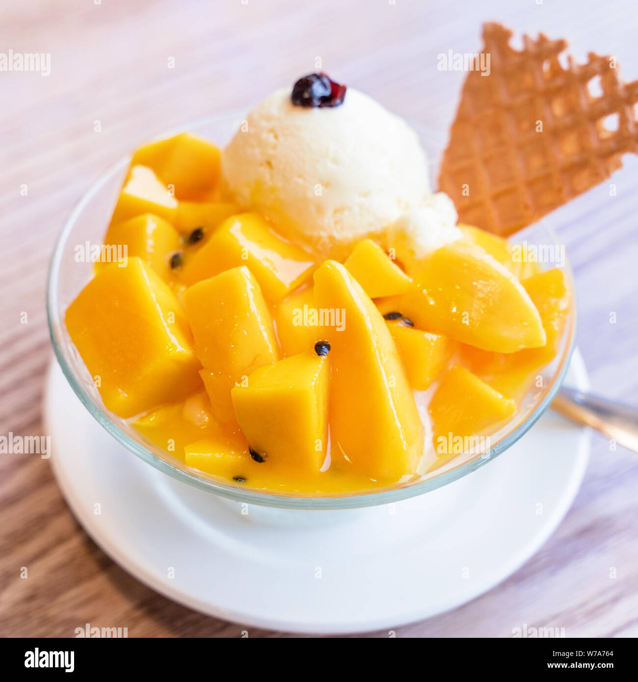 Fresh mango shaved ice with a scoop of ice cream and juice sauce in