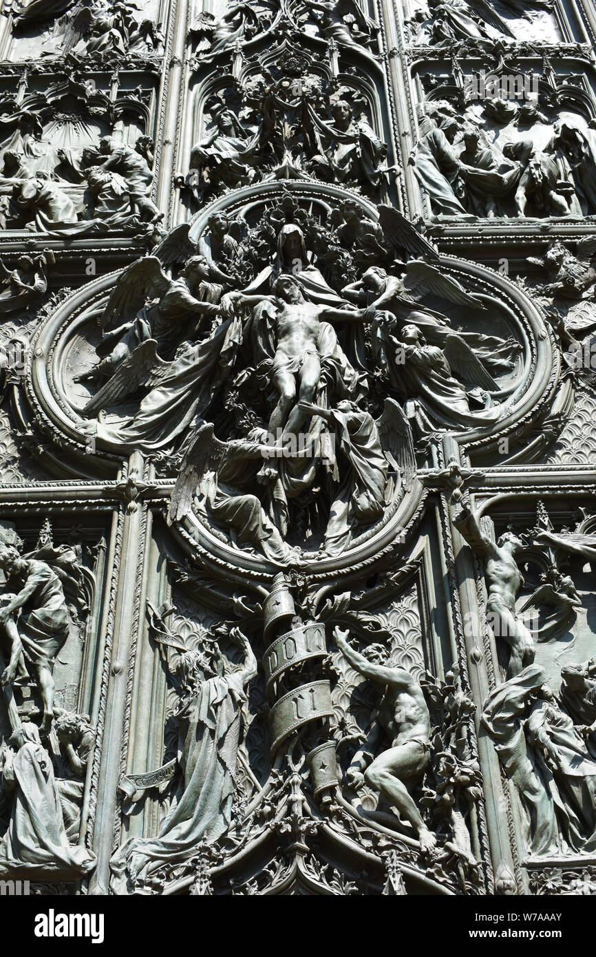 ANGELS OF MEN A beautifully decorative sculptured church door of Duomo MIlan in Italy Stock Photo