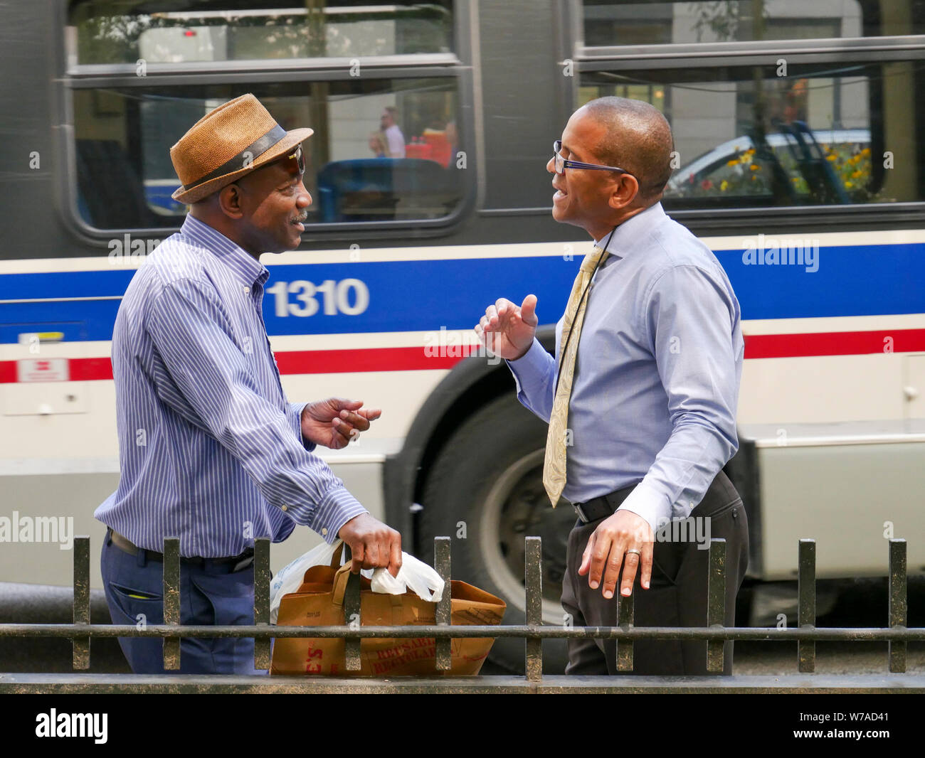 Two men engrossed in conversation. Michigan Avenue, Chicago, Illinois. Stock Photo