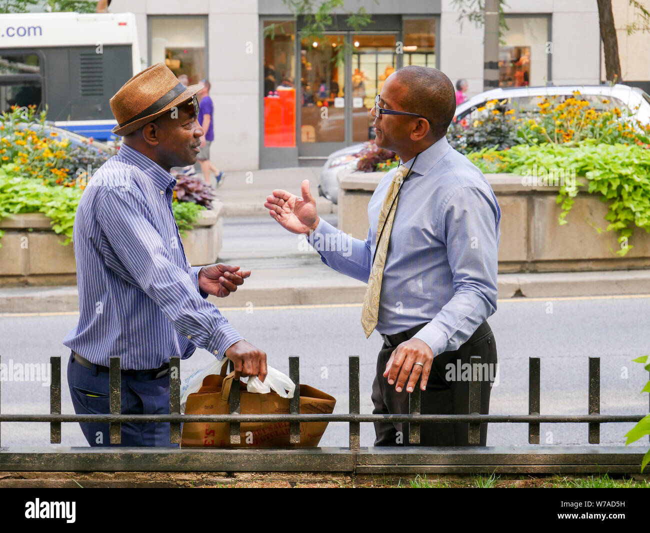 Two men engrossed in conversation. Michigan Avenue, Chicago, Illinois. Stock Photo
