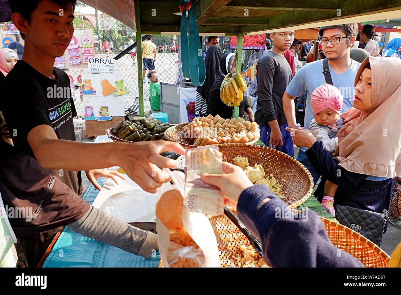 A view of seller and buyer in a street food booth. Stock Photo