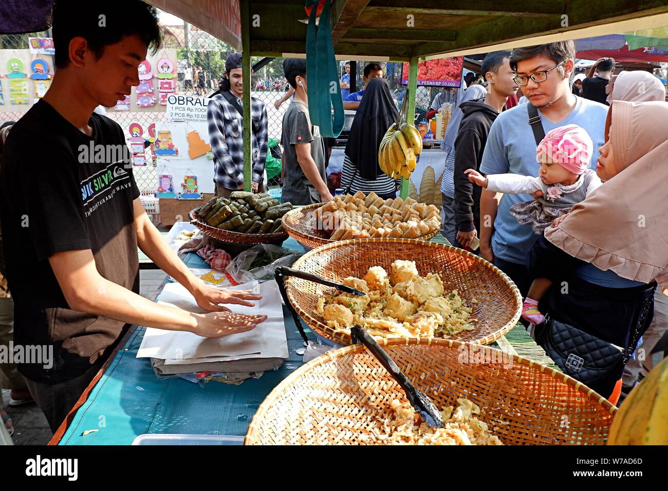 A view of seller and buyer in a street food booth. Stock Photo