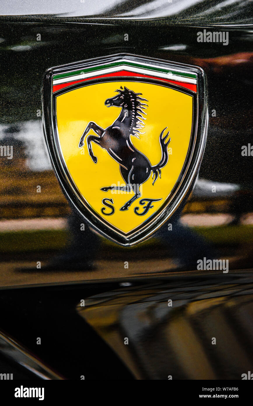GERMANY, FULDA - JUL 2019: A close-up of the Ferrari logo on a black car. Stock Photo