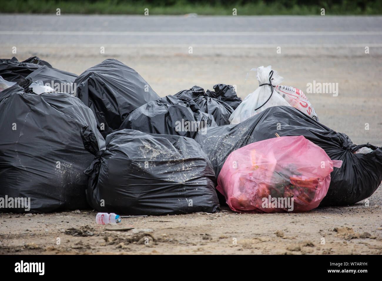 Pile of Garbage plastic black and trash bag waste many on the side