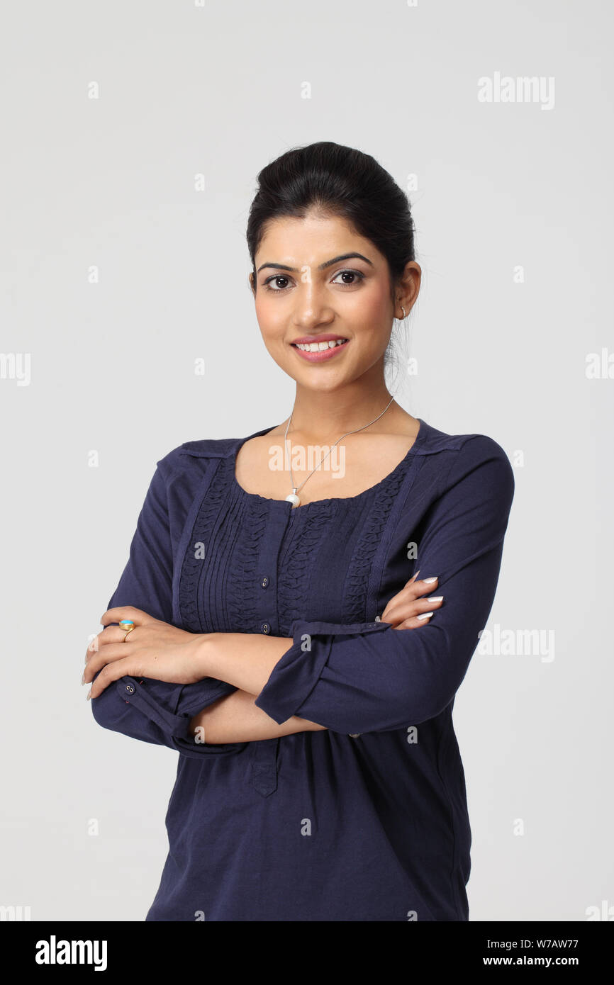 Young woman smiling with her arms crossed Stock Photo - Alamy