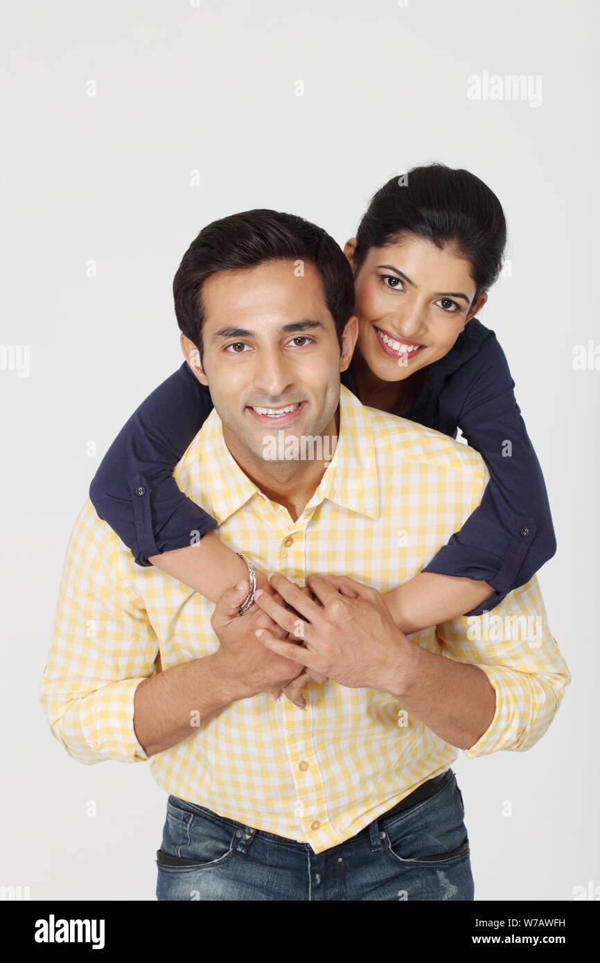 Man giving and adult woman a piggyback ride laughing and having fun in San  Diego, California. Stock Photo