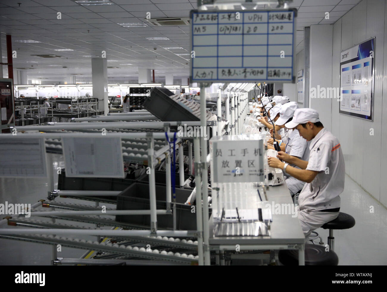 Chinese workers produce robots on the assembly line at China's largest ...