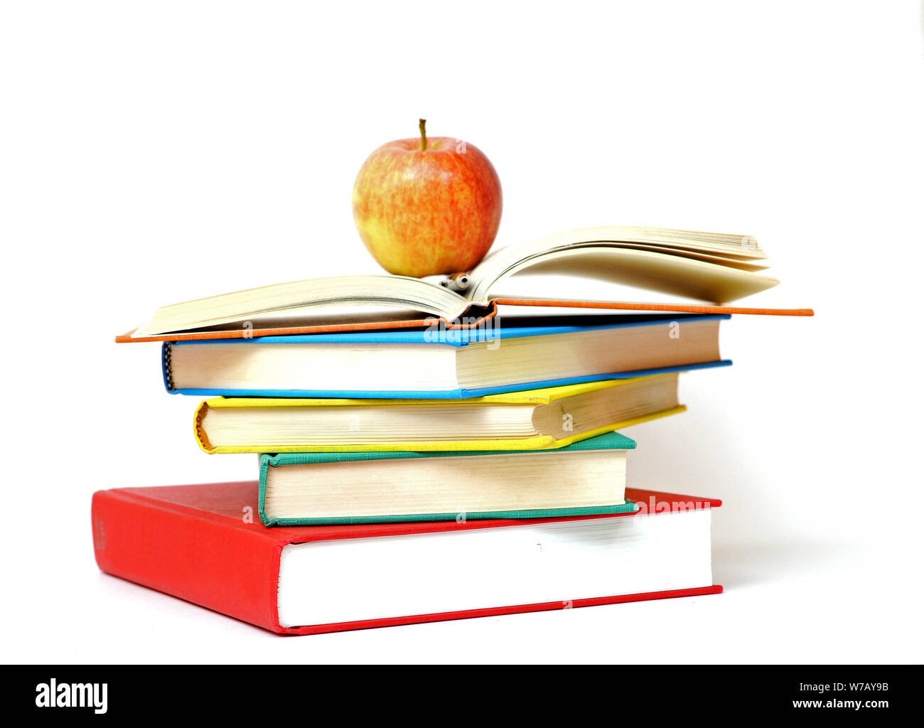 a pile of book and apple on white background Stock Photo - Alamy