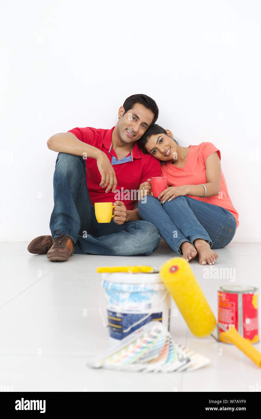 Young couple having cup of tea Stock Photo - Alamy