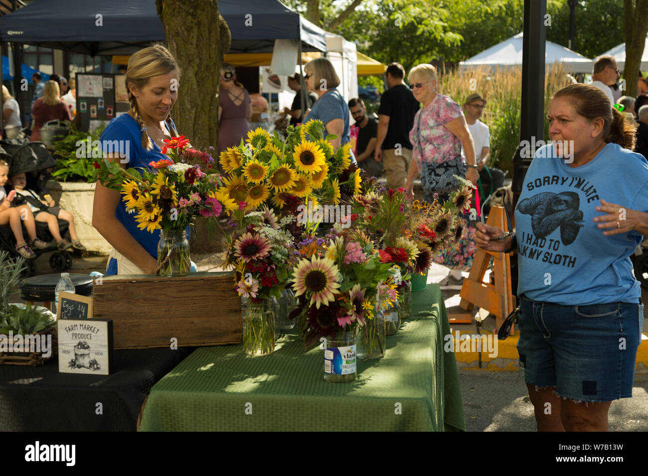 A vendor displays bouquets of flowers to patrons of Fort Wayne's Farmers' Market in downtown