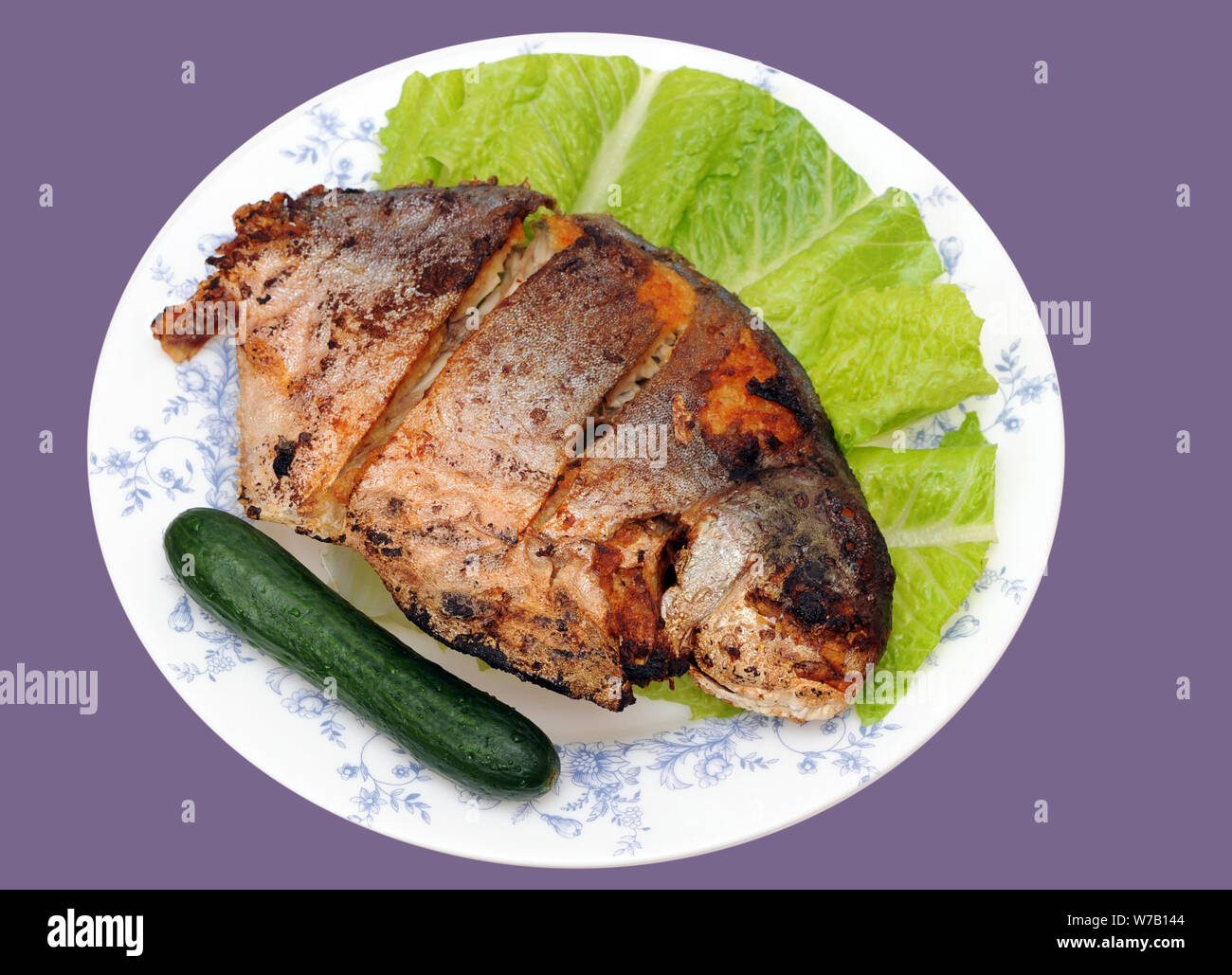 deep fried butter fish dish isolated on purple background Stock Photo