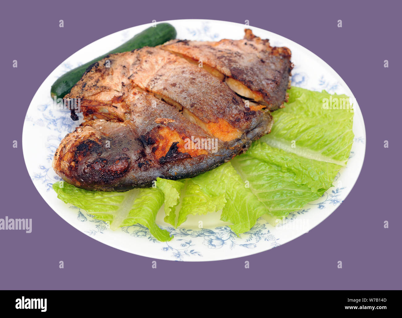 deep fried butter fish dish isolated on purple background Stock Photo