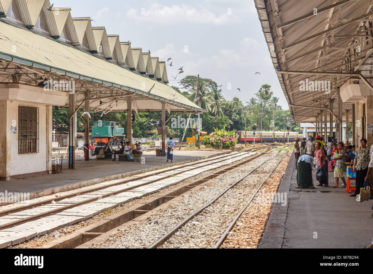 Yangon, Myanmar-May 5th 2014: People waiting on the platform at the main railway station. Railways were introduced during the British colonial period. Stock Photo