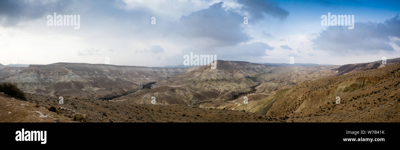 Panoramic view of the crater Ramon from Sde Boker. Somewhere in these places the biblical forefathers roamed. The world's largest erosion crater. Stock Photo