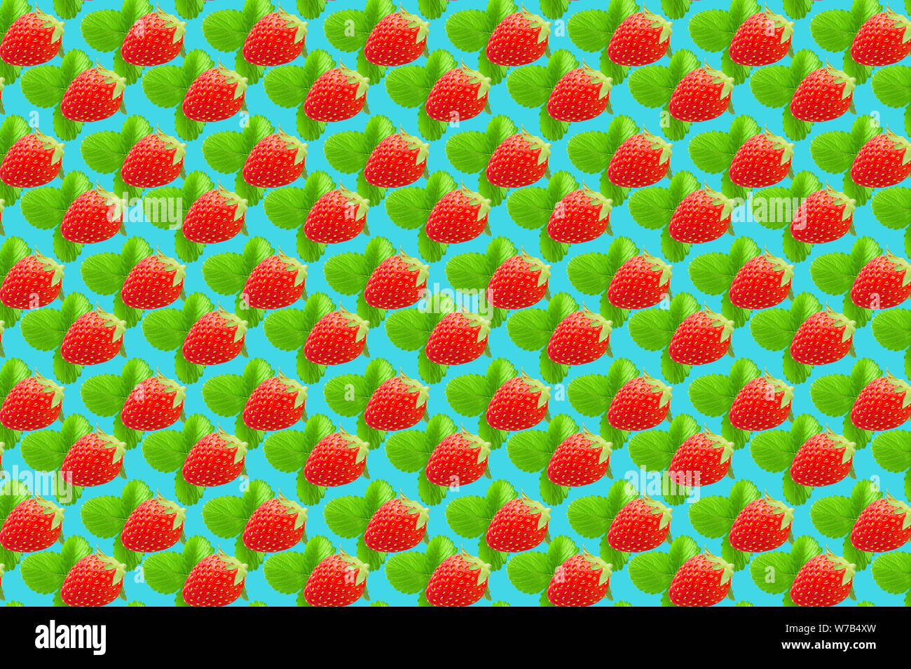 Fruit pattern. Colorful fresh strawberries texture slices on light blue pastel background. From top view. Stock Photo