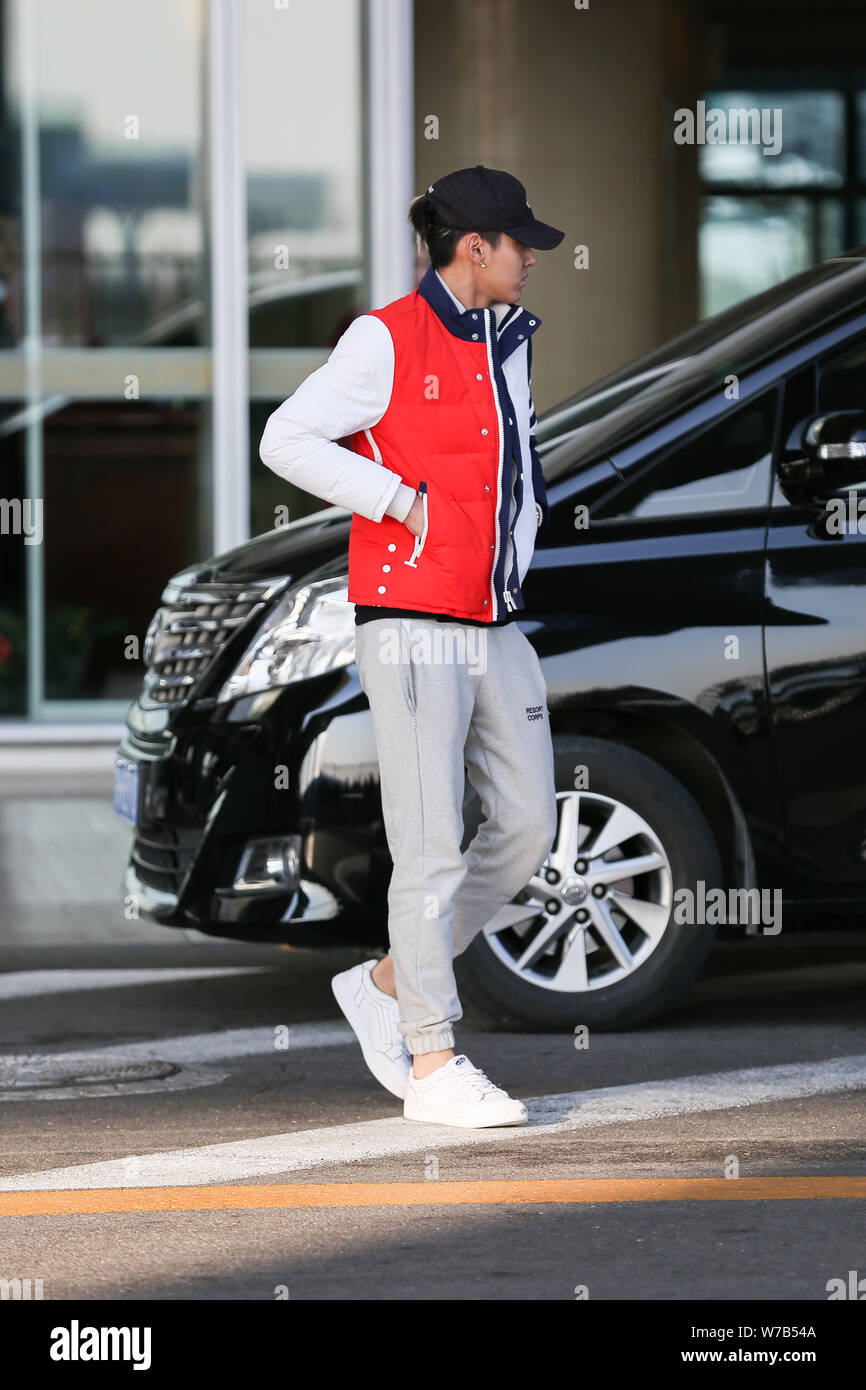 Chinese singer and actor Kris Wu or Wu Yifan approaches a car at