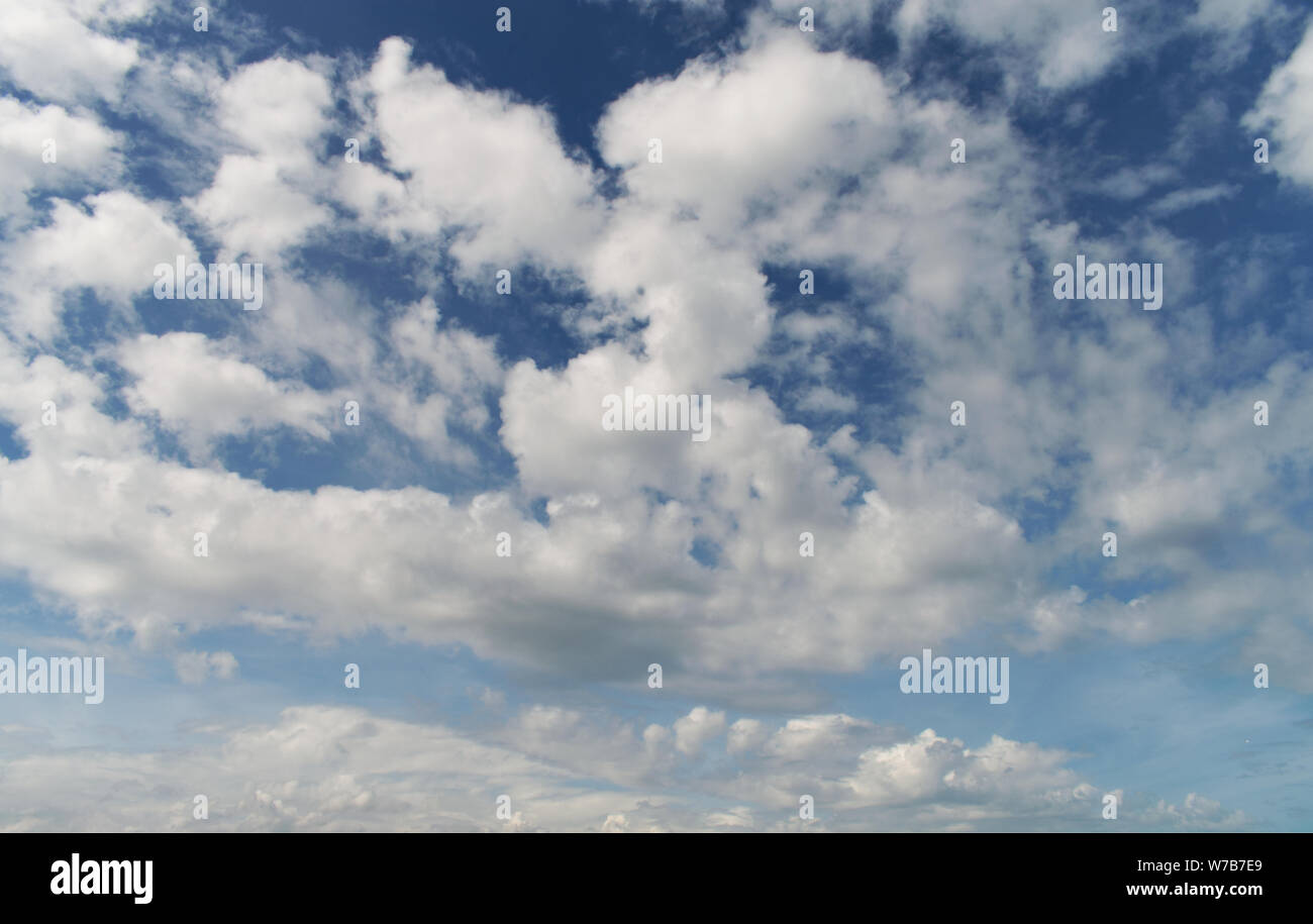 Bright blue sky with white fluffy clouds Stock Photo - Alamy