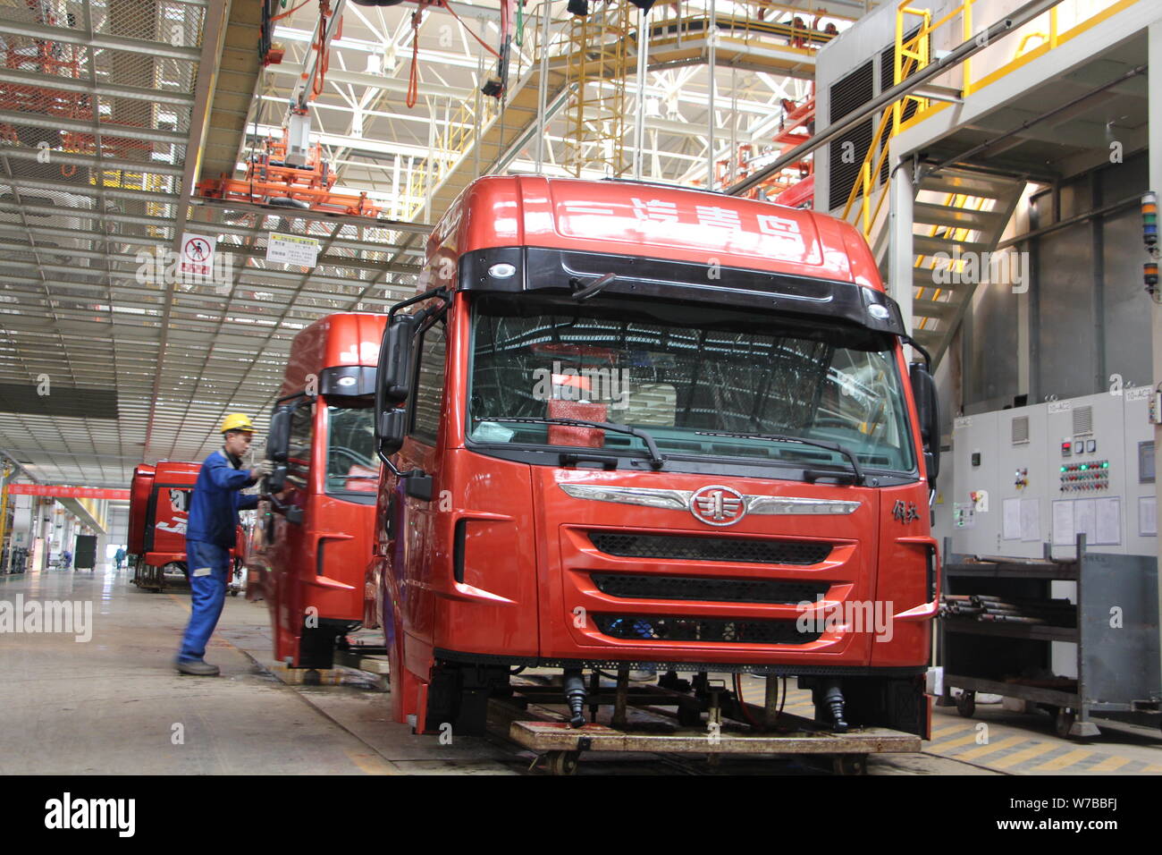 --FILE--A Chinese worker assembles trucks on the assembly line at an ...