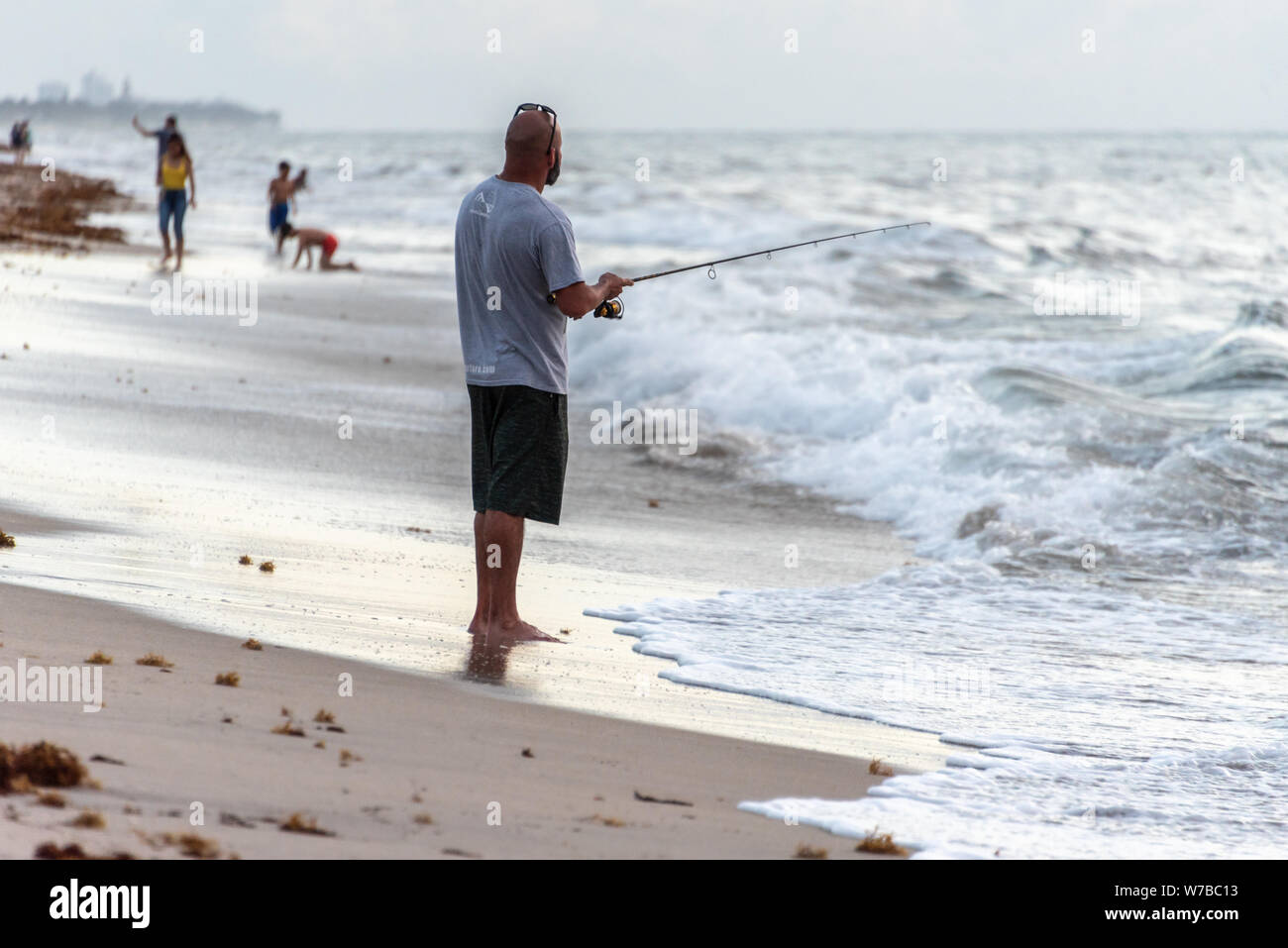 Surf fishing at daybreak on the shore at Lake Worth Beach in Palm Beach County, Florida. (USA) Stock Photo
