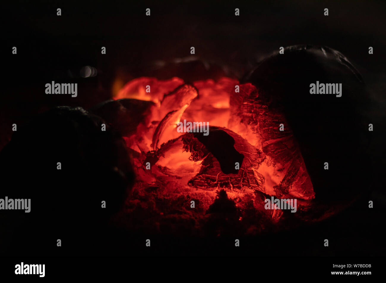 crest of flame on burning wood in fireplace India. Stock Photo