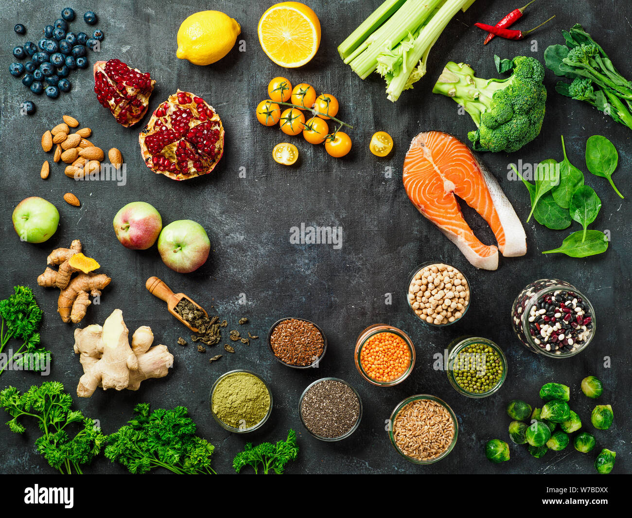 Clean Eating concept with copy space in center. Selection food ingredients for Clean Eating on dark background. Top view or flat lay. Stock Photo