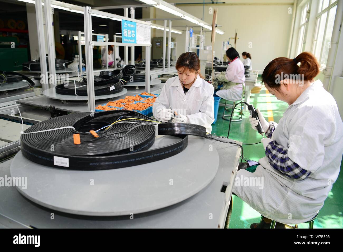 FILEFemale Chinese workers produce cables on the cable assembly