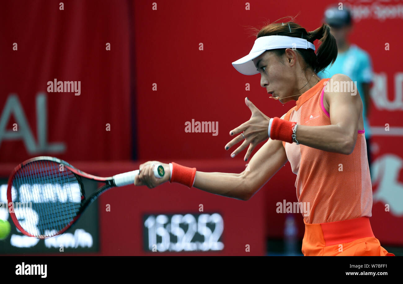 Wang Qiang of China returns a shot to Luksika Kumkhum of Thailand in