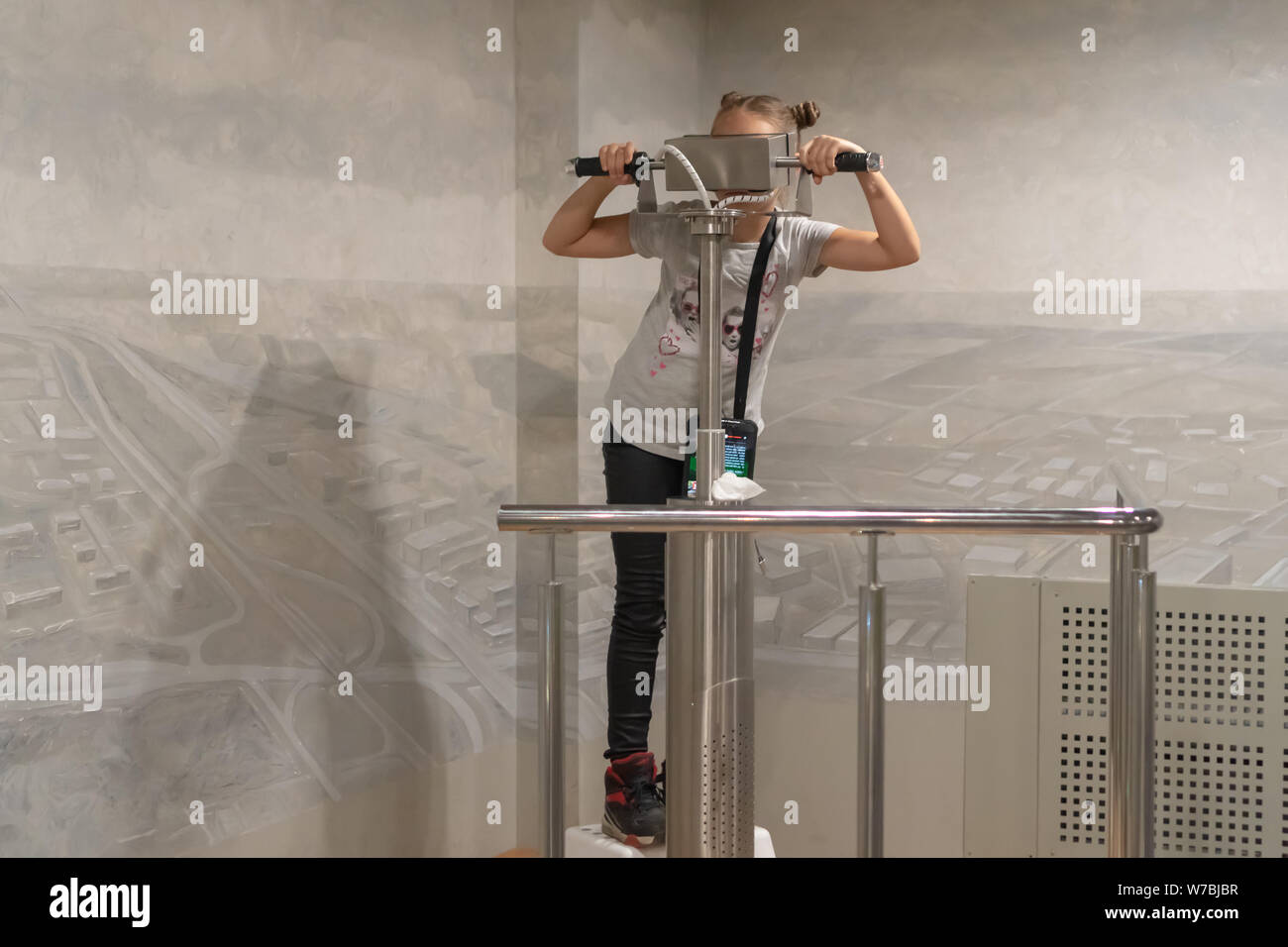 Teen girl look in periscope in the museum. The virtual reality in look-see Stock Photo - Alamy