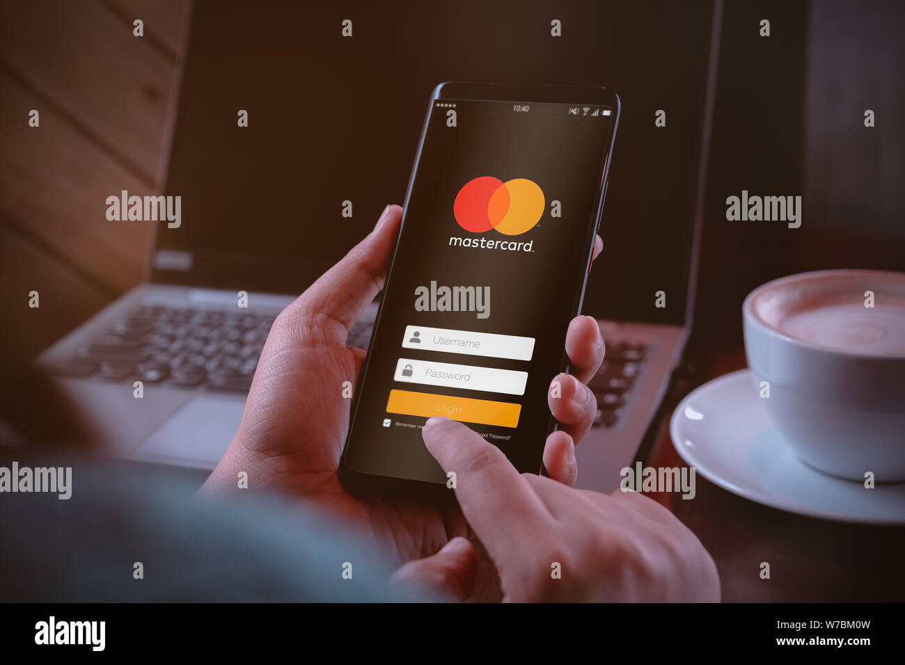 Bangkok, Thailand - August 6, 2019: Mastercard crypto wallet concept. Hands holding Smartphone with Mastercard log on screen. Mastercard Is Building a Stock Photo