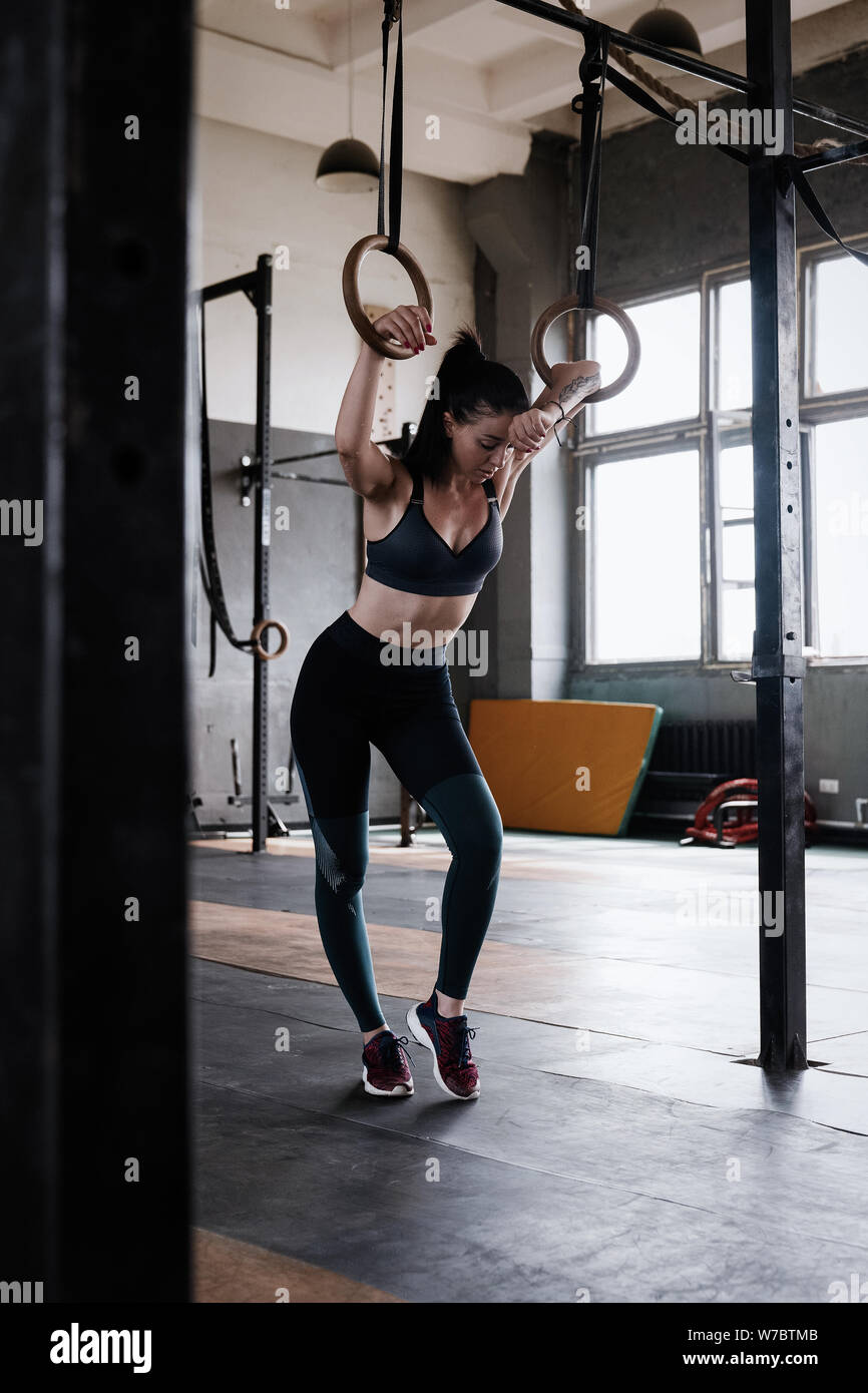 Happy healthy athletic woman laughing, resting after gymnastic rings workout.  Cheerful crossfit female athlete relaxing at the gym, after exercising  Stock Photo - Alamy