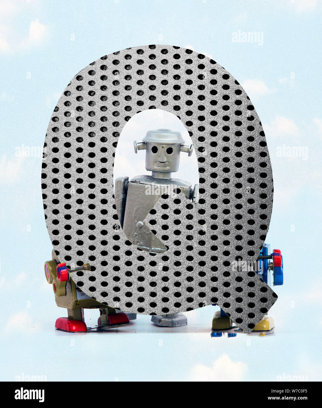 retro robots holding a big metal letter Q with blue sky and clouds ...
