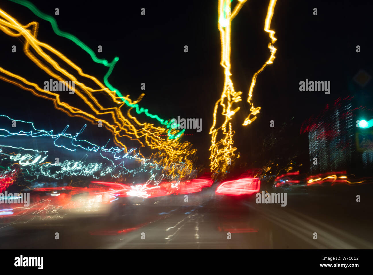 Blurred Defocused Lights of Heavy Traffic on a Wet Rainy. traffic lights in motion blur. Stock Photo