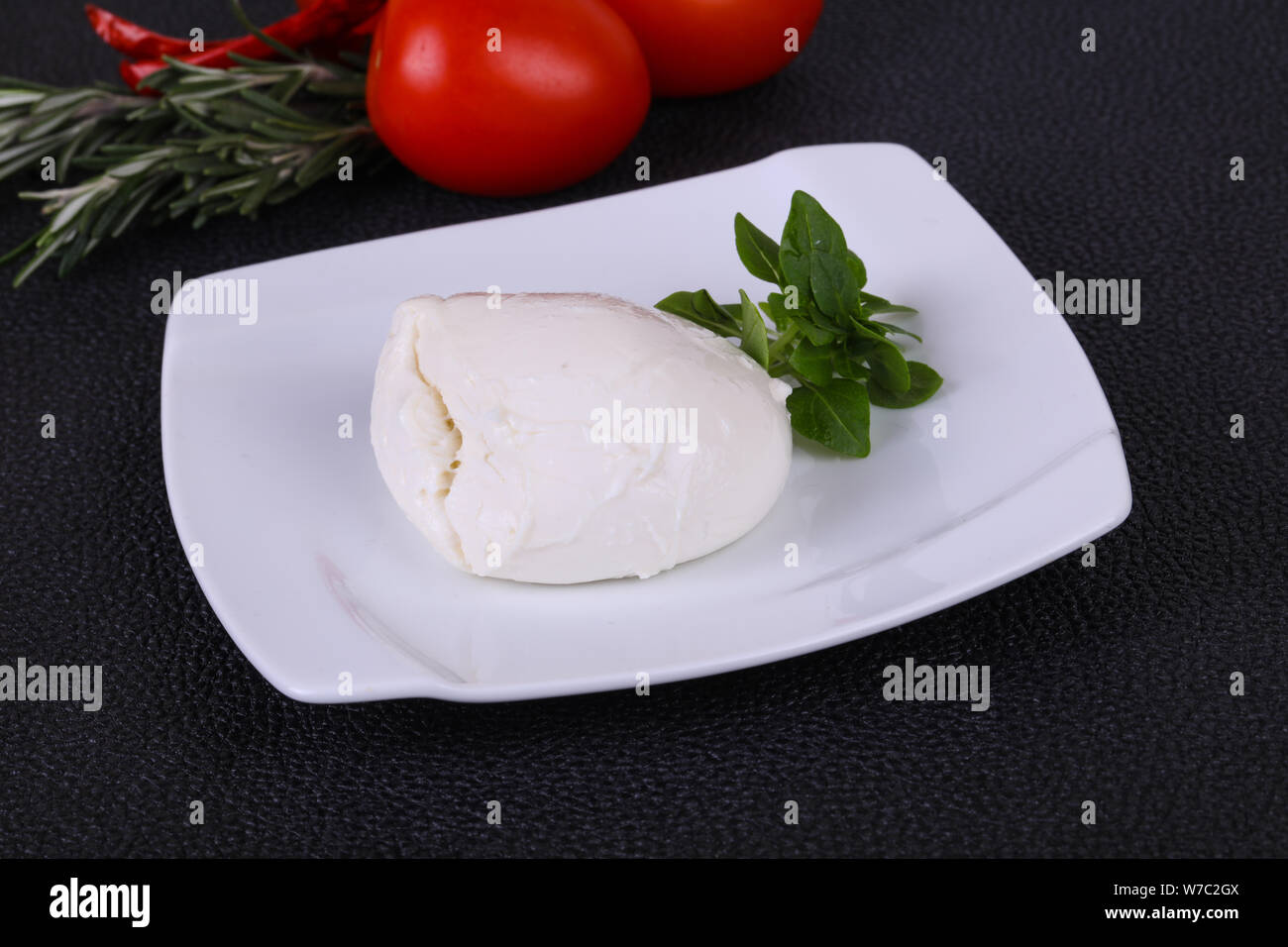 Italian Mozzarella cheese ball served basil and tomatoes Stock Photo