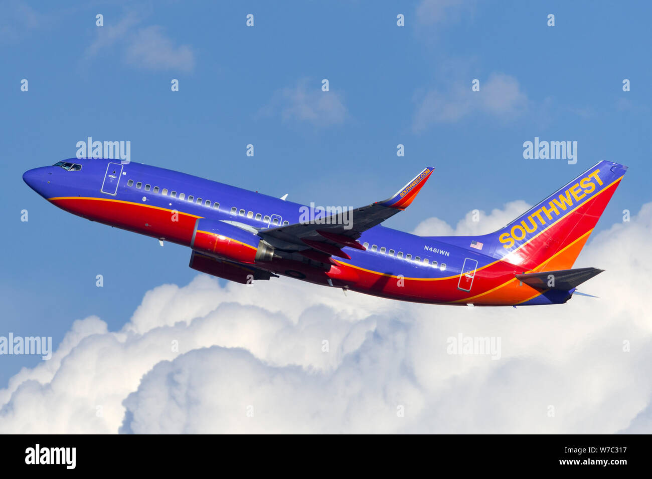 Southwest Airlines Boeing 737 flying past a large cloud formation Stock ...