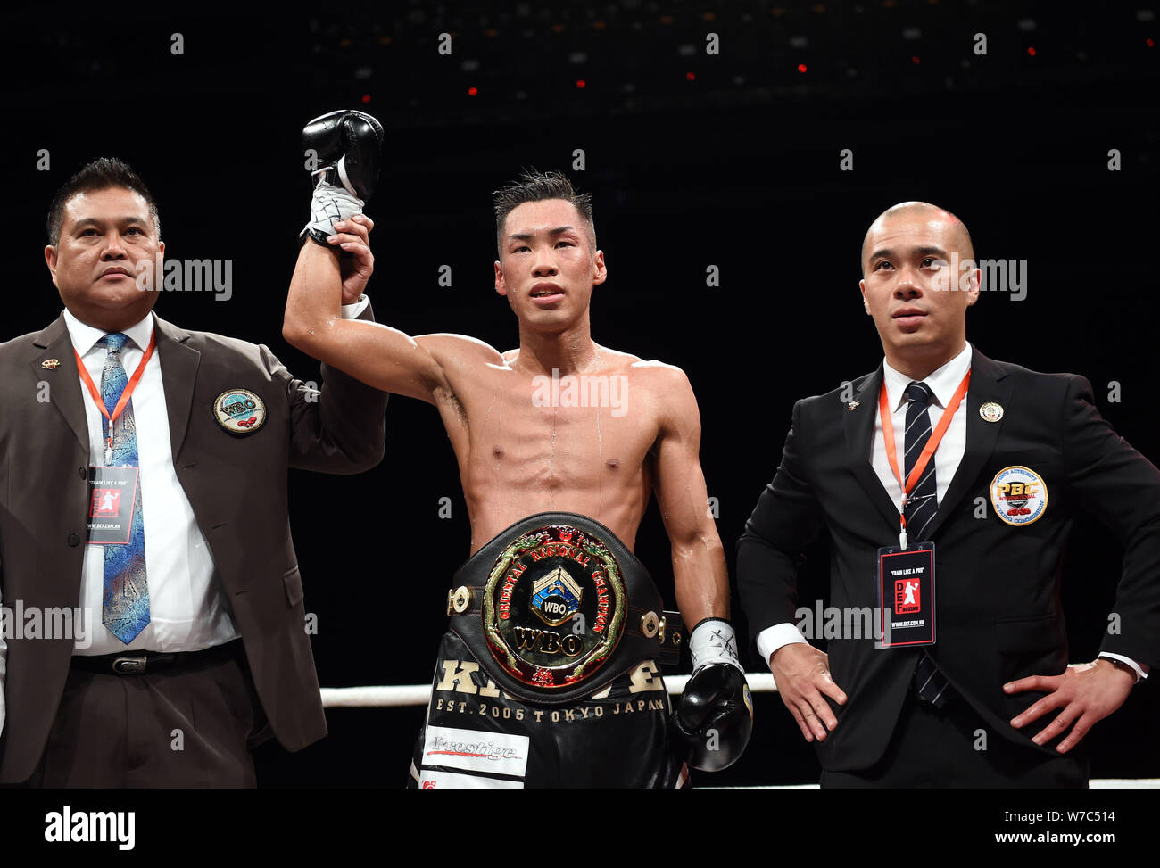 Takuya Watanabe, center, of Japan, celebrates after winning the WBO super featherweight  intercontinental title bout against Li Leshan of China during Stock Photo